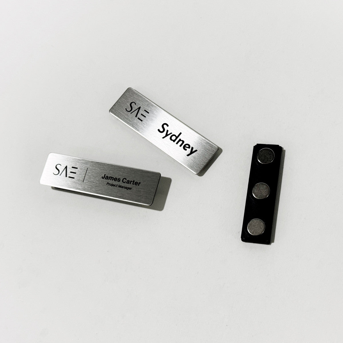 Silver stainless steel laser engraved magnetic name badge for office or retail staff
