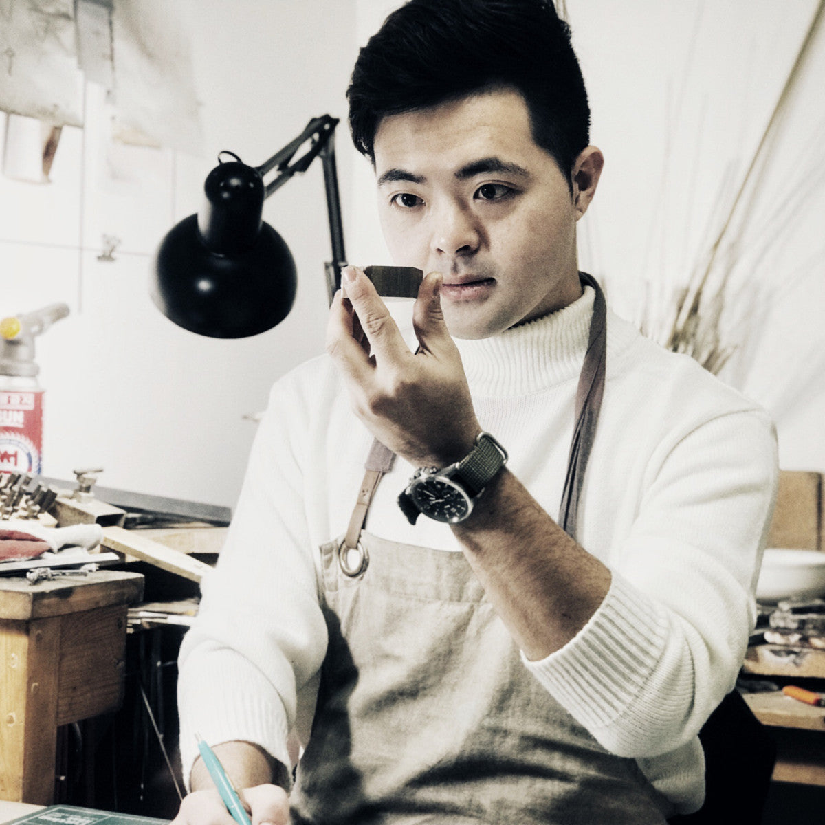 Founder of SAE METAL WORK performing a final inspection under natural lighting before packaging; representing the human touch behind each product.